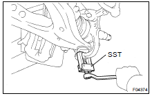 DISCONNECT LOWER SUSPENSION ARM FROM STEERING KNUCKLE