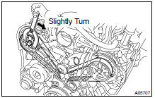 DISCONNECT TIMING BELT FROM CAMSHAFT TIMING PULLEYS
