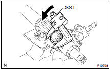 Using SST, remove the nut.