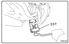 DISCONNECT STEERING KNUCKLE FROM LOWER SUSPENSION ARM