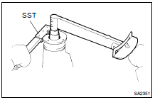 (c) Using SST to hold the flange, install the nut.