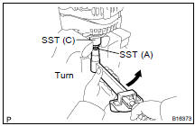 (f) To torque the pulley nut, turn SST (A) in the direction
