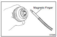 Using a magnetic finger, remove the steel ball from the clutch