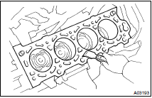 CLEAN TOP SURFACES OF PISTONS AND CYLINDER BLOCK