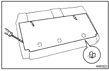 Using a screwdriver, remove the seatback board as shown in