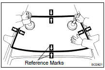 (a) Position the glass so that the reference marks are lined